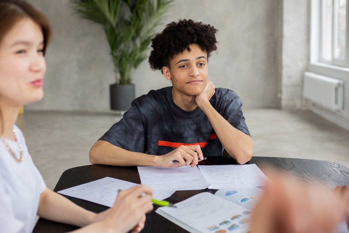 Diverse students sharing ideas around a table