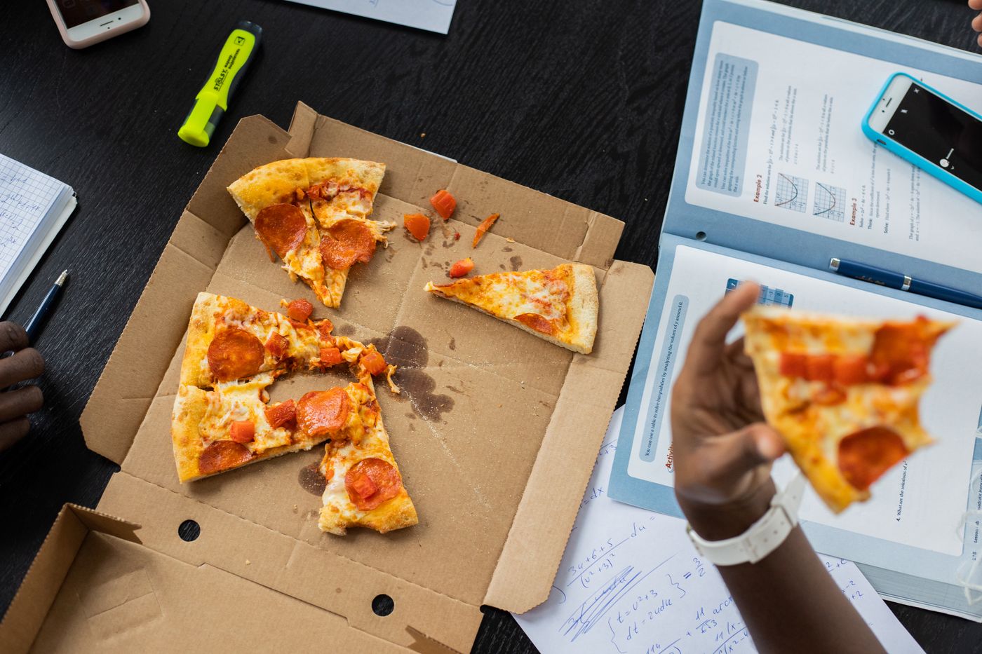 Black classmates sharing food and study time